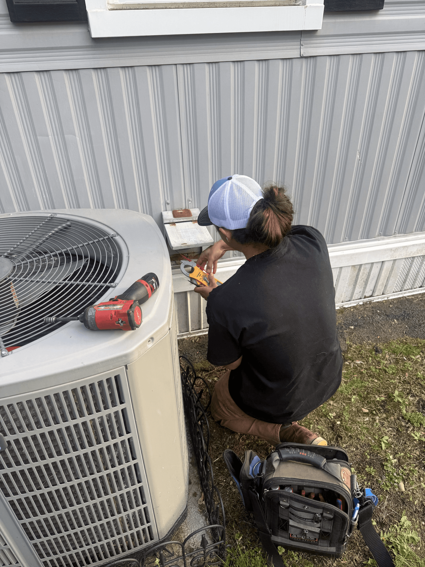 Verifying electrical at the disconnect with a clamp meter — we measure, we don't guess