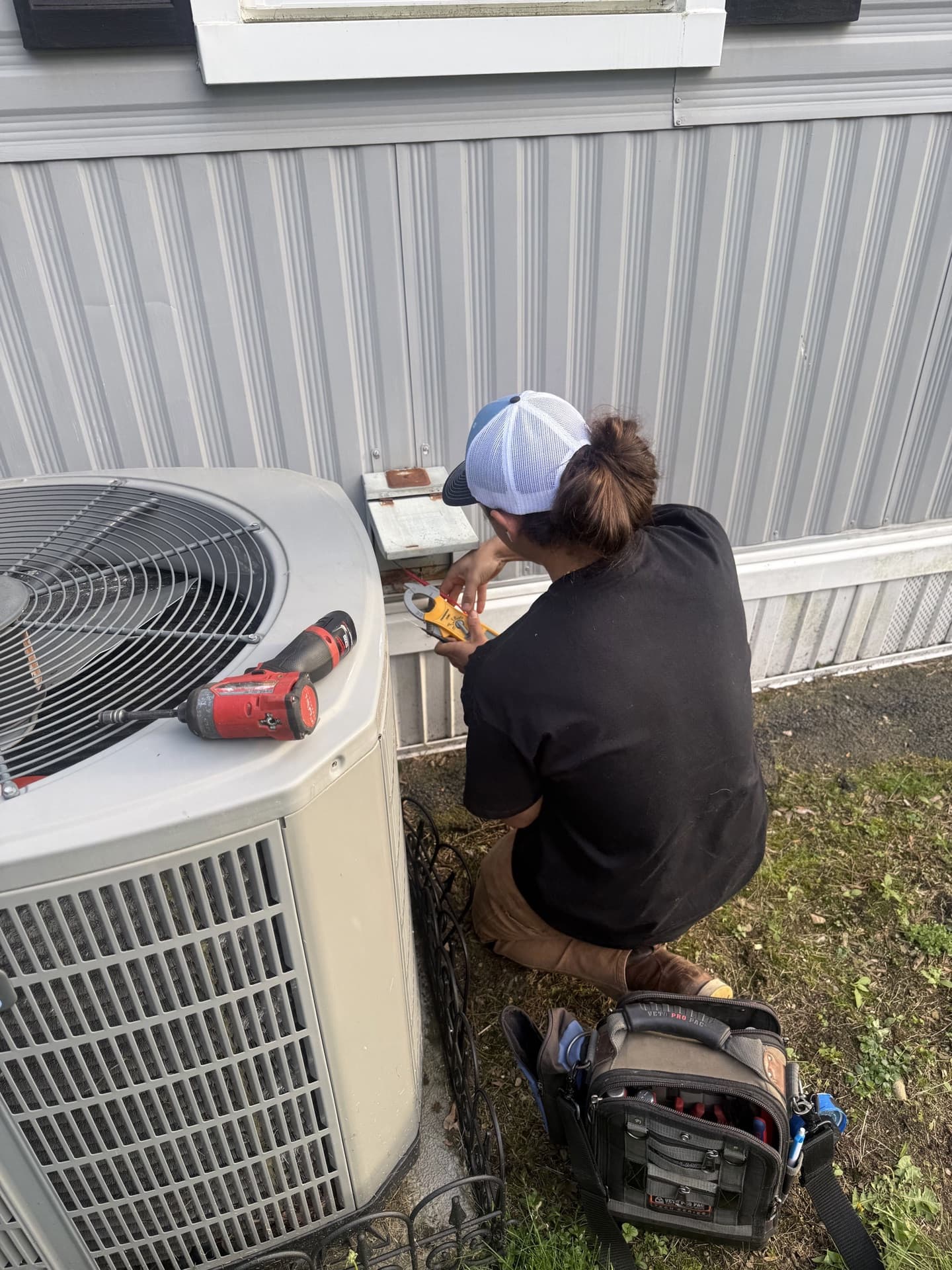 Verifying electrical at the disconnect with a clamp meter — we measure, we don't guess
