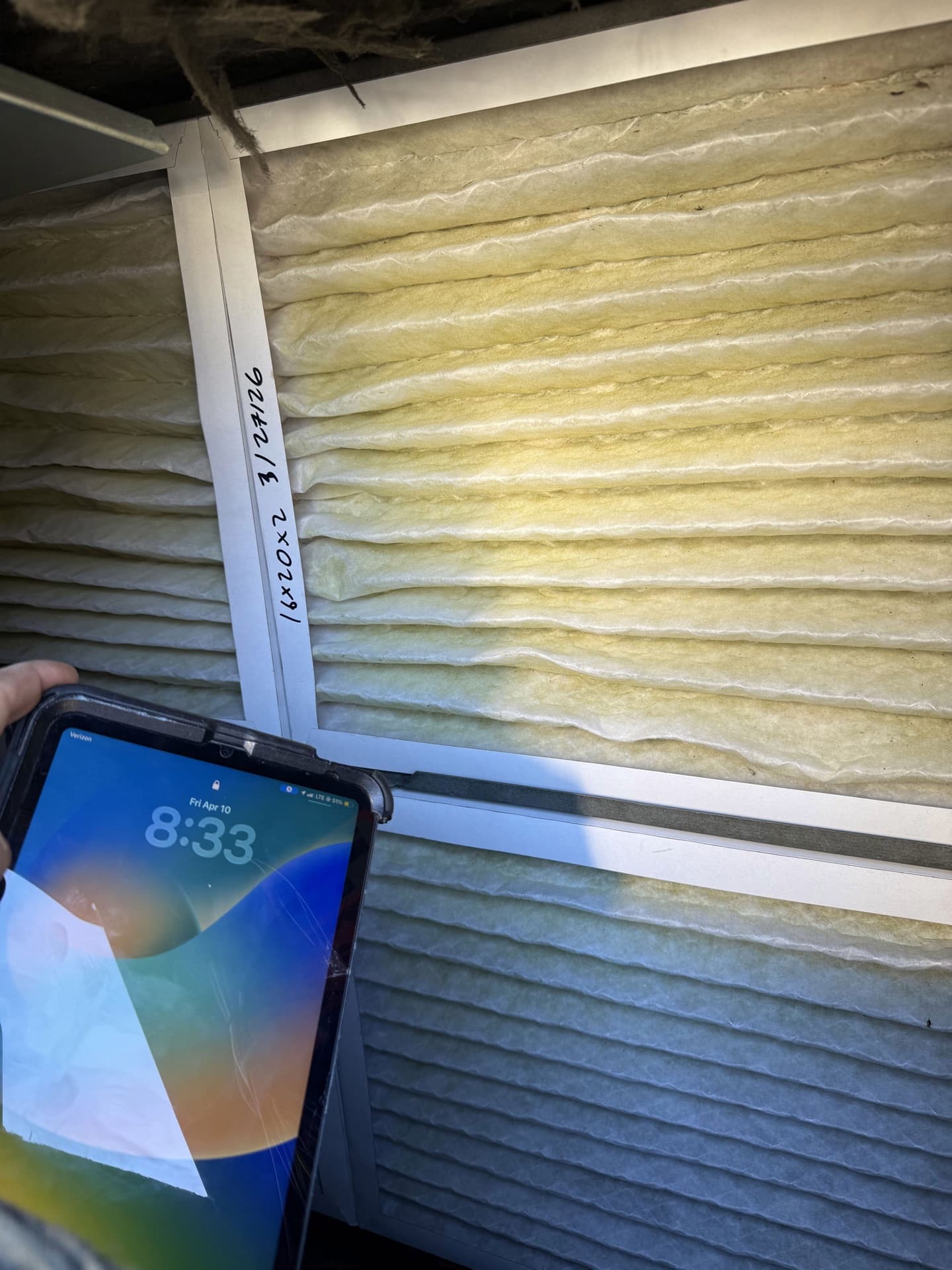 A clogged filter pulled from a neglected return — six months of dust and pollen